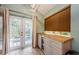 Bright kitchen area featuring wood countertops and view of the outdoor pool area at 678 Greenglen Ln, Palm Harbor, FL 34684