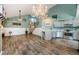 Spacious living room with open kitchen, vaulted ceilings, and stylish wood-look floors at 678 Greenglen Ln, Palm Harbor, FL 34684