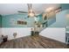 View of the open living area with staircase and coastal decorations on the walls at 678 Greenglen Ln, Palm Harbor, FL 34684