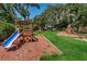 Inviting community playground with slides and a climbing area framed by mature shade trees at 678 Greenglen Ln, Palm Harbor, FL 34684