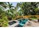 Backyard pool with tropical foliage surround and brick patio and a spa is the perfect place to relax at 678 Greenglen Ln, Palm Harbor, FL 34684