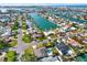 Panoramic aerial view of a waterfront community with homes, canals, and ocean access at 680 Capri Blvd, Treasure Island, FL 33706