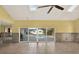 A spacious living room with vaulted ceilings, skylights, and large sliding doors at 680 Capri Blvd, Treasure Island, FL 33706