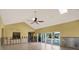 A spacious living room features vaulted ceilings, a skylight, and sliding glass doors that lead to the pool at 680 Capri Blvd, Treasure Island, FL 33706