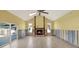 A spacious living room features a cozy fireplace, vaulted ceilings, and large windows at 680 Capri Blvd, Treasure Island, FL 33706