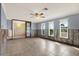 A light and bright living room with three large windows and sliding doors at 680 Capri Blvd, Treasure Island, FL 33706