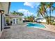 Stunning pool area with a patio, palm trees, and a beautiful home exterior at 680 Capri Blvd, Treasure Island, FL 33706