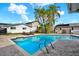 Inviting backyard featuring a pool, surrounded by palm trees and a well-manicured patio at 680 Capri Blvd, Treasure Island, FL 33706