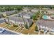 Aerial view of townhome community featuring pool, parking, and landscaping on a sunny day at 7021 White Treetop Pl, Riverview, FL 33578