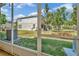 View of the backyard featuring green grass and AC unit outside of the screened in patio on a sunny day at 7021 White Treetop Pl, Riverview, FL 33578