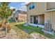 Backyard of a townhome with a screened in porch, lawn, and central air conditioning unit at 7021 White Treetop Pl, Riverview, FL 33578