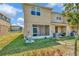 View of the back exterior of a townhome with a screened in porch and green yard at 7021 White Treetop Pl, Riverview, FL 33578