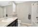 Well-lit bathroom features a shower-tub combo, a toilet, and a vanity with sink at 7021 White Treetop Pl, Riverview, FL 33578
