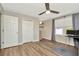 Bedroom with wood-look floors, ceiling fan, closet, and natural light from the window at 7021 White Treetop Pl, Riverview, FL 33578