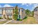 Charming two-story townhouse featuring lush landscaping and a well-maintained lawn at 7021 White Treetop Pl, Riverview, FL 33578