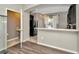 Modern kitchen with breakfast bar, black appliances, and neutral finishes at 7021 White Treetop Pl, Riverview, FL 33578