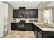 Lovely kitchen featuring dark wood cabinets, modern appliances, and neutral countertops at 7021 White Treetop Pl, Riverview, FL 33578