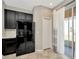 Kitchen area with stainless steel refrigerator, adjacent closet, and sliding door access at 7021 White Treetop Pl, Riverview, FL 33578