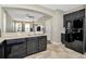 Open-concept kitchen featuring sleek black appliances, a breakfast bar, and tile flooring at 7021 White Treetop Pl, Riverview, FL 33578