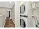 Laundry area on upper level with stacked washer and dryer and storage shelves at 7021 White Treetop Pl, Riverview, FL 33578