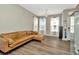 Bright and airy living room with wood-look floors, neutral walls, and elegant lighting at 7021 White Treetop Pl, Riverview, FL 33578
