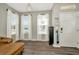 Inviting living room featuring hardwood floors and large windows with bright, natural light at 7021 White Treetop Pl, Riverview, FL 33578
