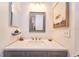 Bright bathroom features a gray vanity, framed mirror and modern fixtures and decor at 7205 San Luis Ct, Tampa, FL 33634