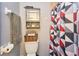 Bathroom showcasing a cabinet, toilet, and vibrant shower curtain at 7205 San Luis Ct, Tampa, FL 33634