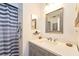 Well-lit bathroom features a gray vanity, modern fixtures, and a framed mirror at 7205 San Luis Ct, Tampa, FL 33634