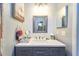 Stylish bathroom featuring a modern vanity, framed mirror, and decorative shower curtain accents at 7205 San Luis Ct, Tampa, FL 33634