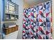Bathroom showcasing a cabinet, toilet, and vibrant shower curtain at 7205 San Luis Ct, Tampa, FL 33634