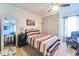 Bedroom featuring tiled flooring, large closet, and comfortable queen bed at 7205 San Luis Ct, Tampa, FL 33634