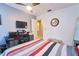 This bedroom features tile floors, neutral walls and ceiling fan at 7205 San Luis Ct, Tampa, FL 33634