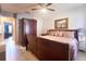 This bedroom features tile floors, a ceiling fan, and ample closet space for storage at 7205 San Luis Ct, Tampa, FL 33634