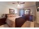 This bedroom features tile floors, a ceiling fan, and ample closet space for storage at 7205 San Luis Ct, Tampa, FL 33634