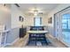Bright dining area with modern table, bench seating, and access to outdoor space at 7205 San Luis Ct, Tampa, FL 33634