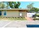Exterior view of home with private courtyard, landscaping, and designated parking space at 7205 San Luis Ct, Tampa, FL 33634