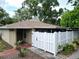 Charming home featuring a gated entrance, well-maintained landscaping, and inviting curb appeal at 7205 San Luis Ct, Tampa, FL 33634