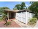 Inviting home featuring a private white-fenced courtyard and lush landscaping around the house at 7205 San Luis Ct, Tampa, FL 33634