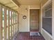 Inviting front porch with decorative wreath, tiled floor, and a stylish front door at 7205 San Luis Ct, Tampa, FL 33634