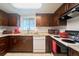 Well-equipped kitchen with dark cabinets, granite countertops, and modern appliances at 7205 San Luis Ct, Tampa, FL 33634