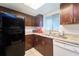 Functional kitchen featuring dark cabinets, granite countertops, and efficient layout at 7205 San Luis Ct, Tampa, FL 33634
