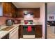 Kitchen featuring granite countertops, wood cabinets, and modern appliances at 7205 San Luis Ct, Tampa, FL 33634