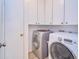 Laundry room with washer, dryer and white cabinets for ample storage at 7205 San Luis Ct, Tampa, FL 33634