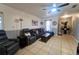 Spacious living room featuring tile floors, ceiling fan, and an open floorplan with room for seating at 7205 San Luis Ct, Tampa, FL 33634