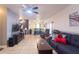 Spacious living room with comfortable seating, ceiling fan, neutral walls, and abundant natural light at 7205 San Luis Ct, Tampa, FL 33634