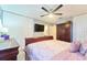 Spacious primary bedroom featuring a king bed, dresser, and a ceiling fan for added comfort at 7205 San Luis Ct, Tampa, FL 33634