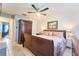 Spacious primary bedroom featuring a king bed, dresser, and a ceiling fan for added comfort at 7205 San Luis Ct, Tampa, FL 33634