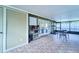 Enclosed patio with tile flooring, equipped with fitness equipment and shelving at 7205 San Luis Ct, Tampa, FL 33634