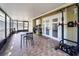 Enclosed patio featuring a table and chairs, pull up bar, and access to the outdoors at 7205 San Luis Ct, Tampa, FL 33634